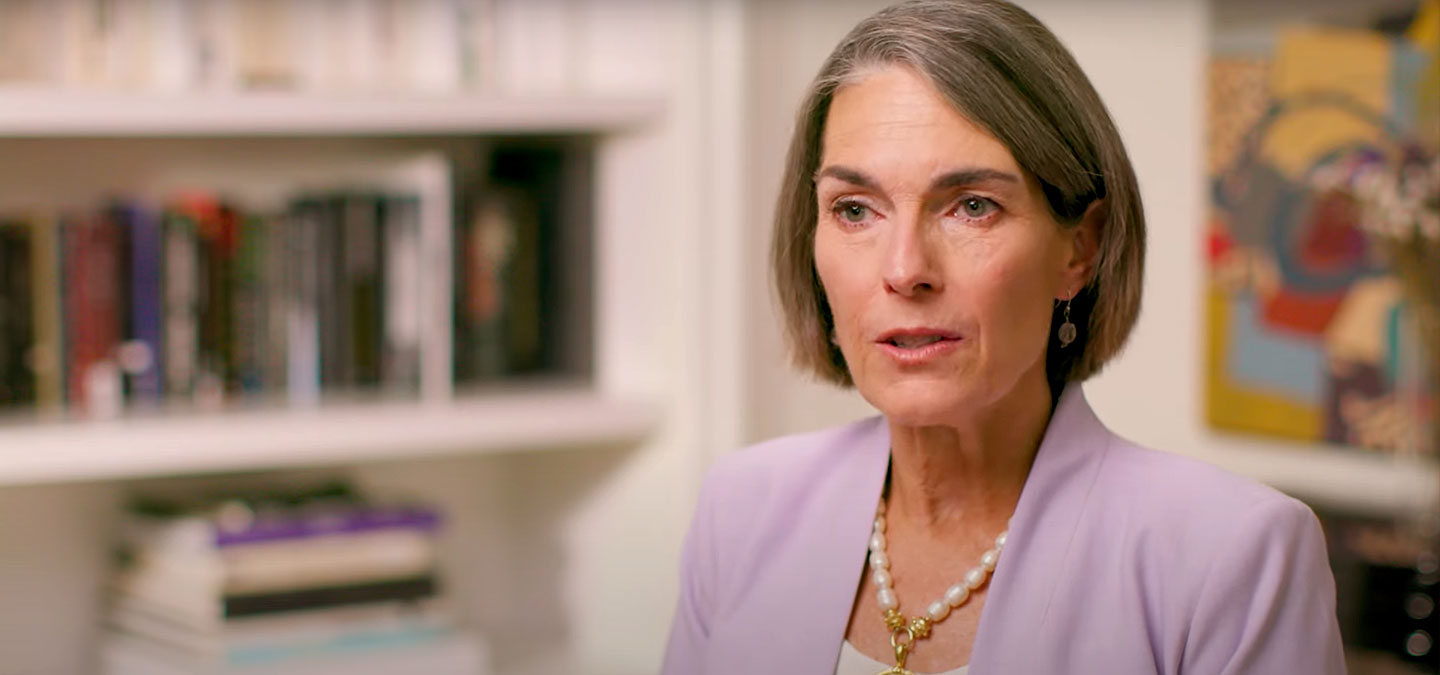 Dr. Susan Harvey in lavender suit.