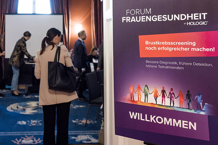 Woman walks into entrance of conference room.