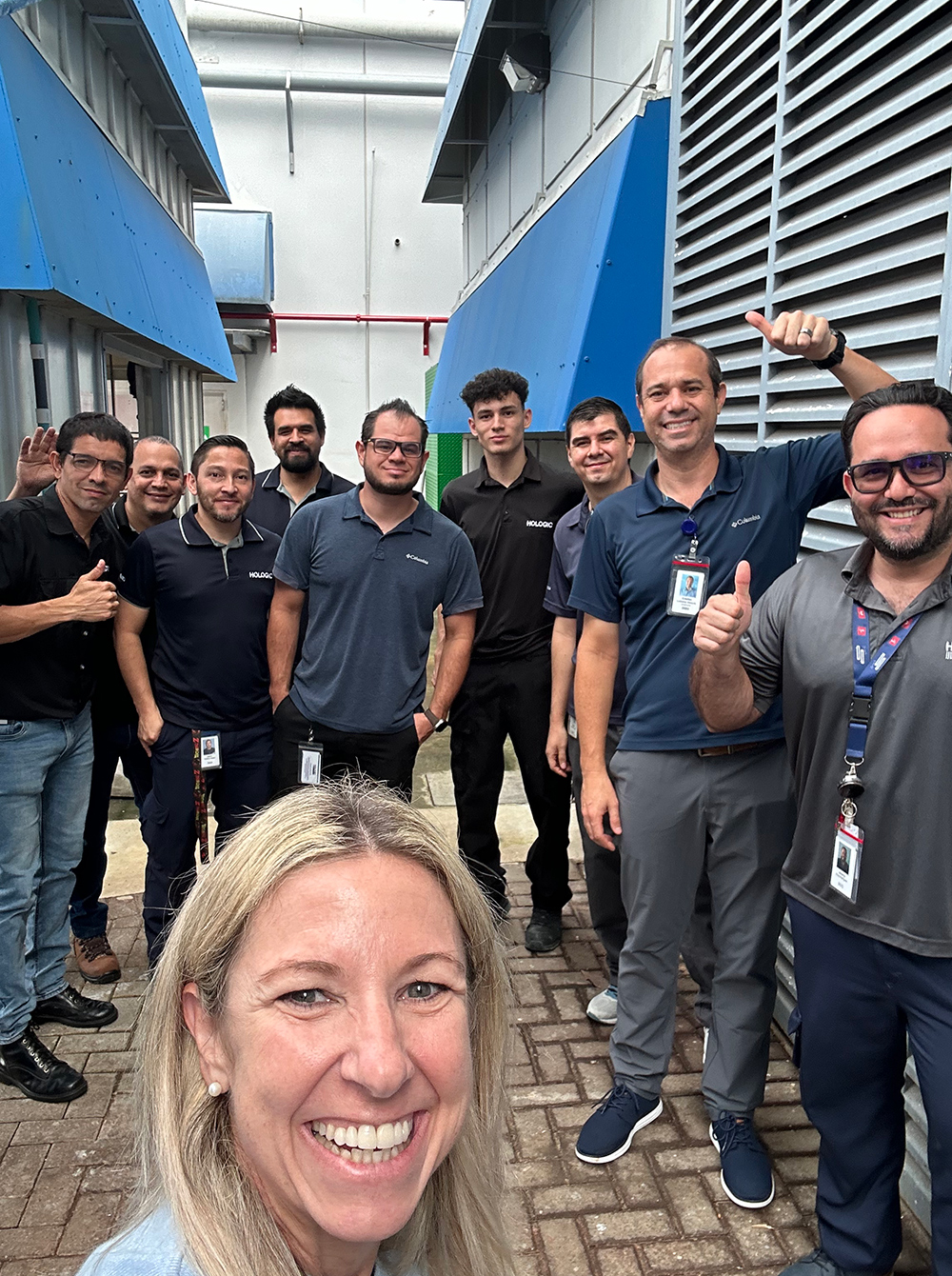 Group of individuals standing together outside an office.