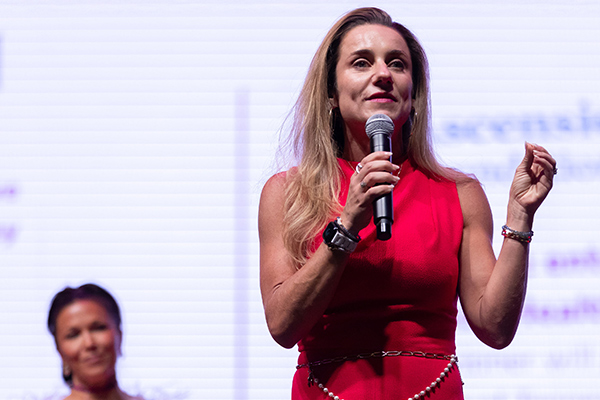 Mary Byerly standing on stage presenting