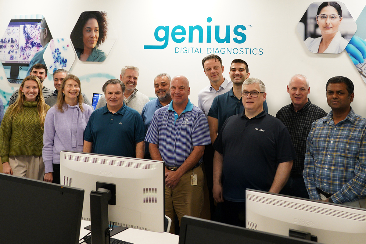 Group of people stranding in front of computer screens.