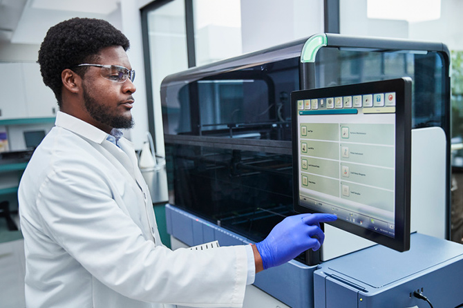 Technician in a lab using a Panther Instrument