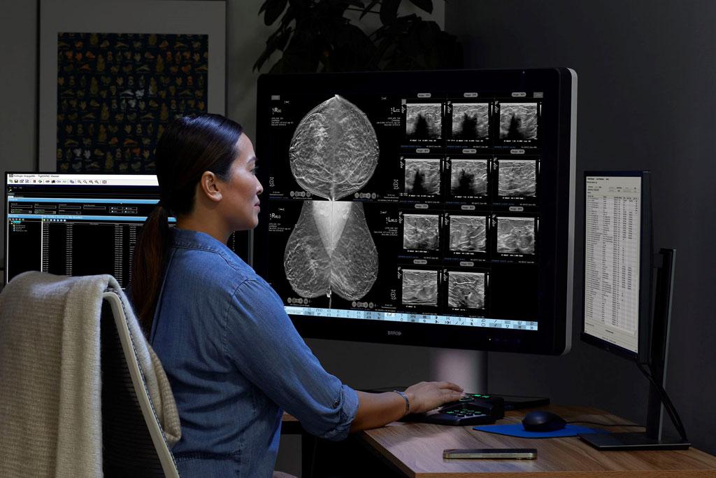Provider looking at x-ray on monitor in dark office