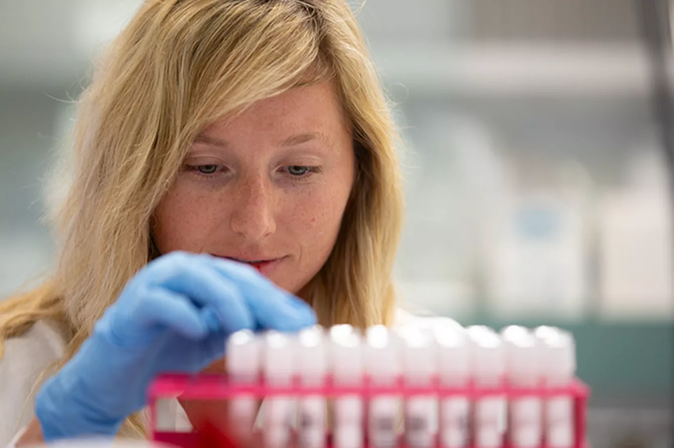 Lab technician inspecting vials