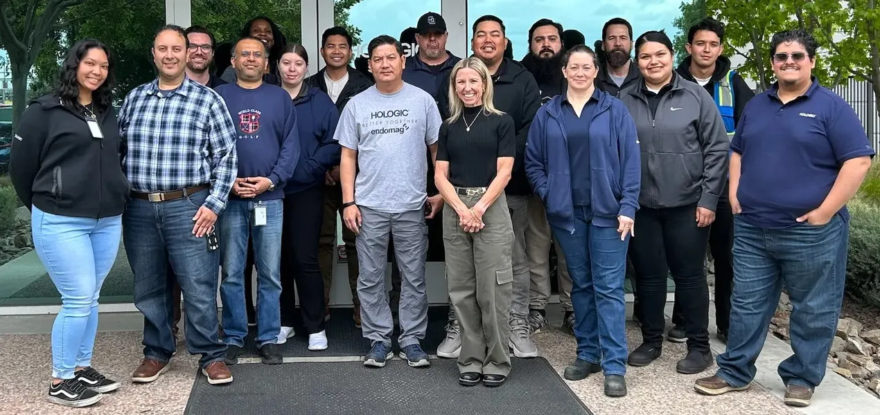 Group photo outside of Hologic building entrance.
