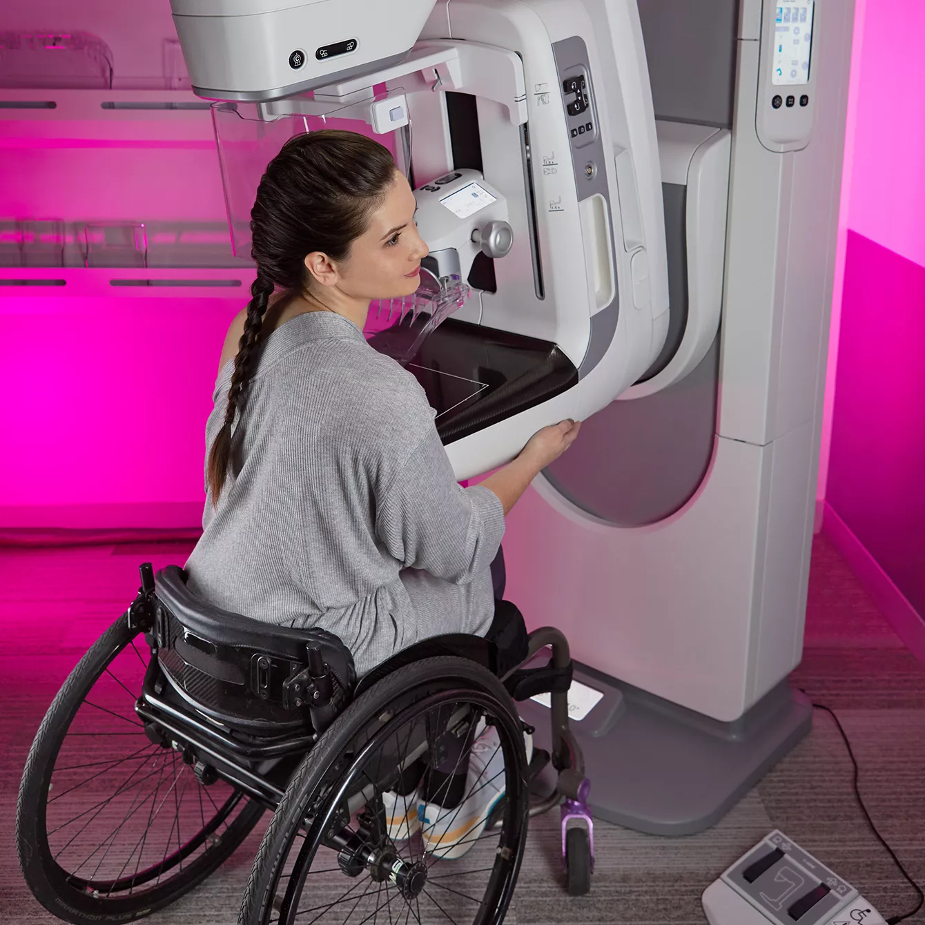 Patient in a wheelchair receiving a mammogram